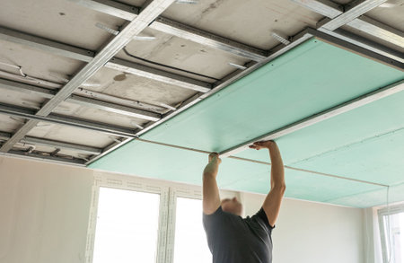 Drywall Installers. Men holding a gypsum board figured cutの写真素材