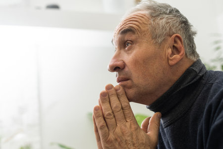 Elderly caucasian man with interlocked fingersの写真素材
