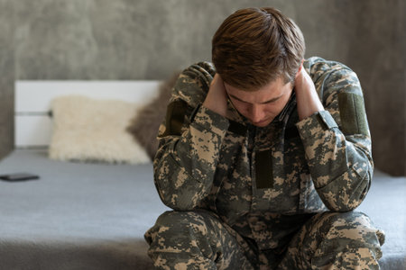 Thoughtful young handsome soldier in military uniform.