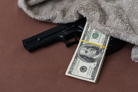 Handgun on the US dollars stack - - criminal money conceptの写真素材