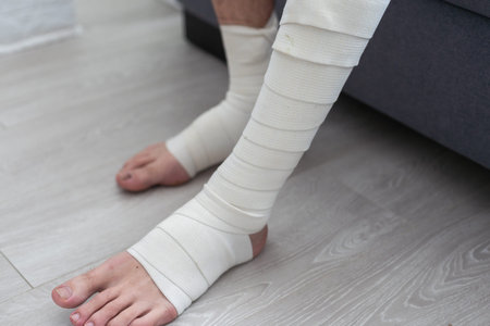 the mans leg is wrapped in an elastic bandage