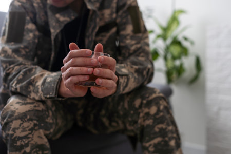 young attractive wasted and depressed addict and alcoholic man with whiskey glass thoughtful and sad failing resisting temptation to drink falling into alcohol abuse addiction and alcoholism problemの写真素材