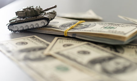 toy tank on the background of dollar billsの写真素材