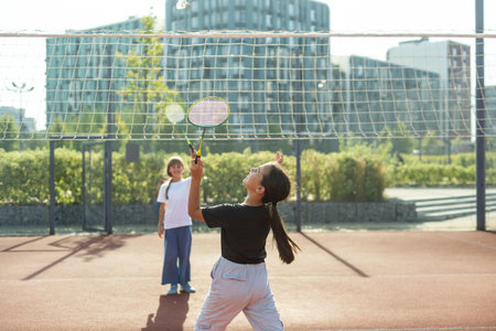 Young girls, athletes shaking hands before game session. Playing tennis on warm sunny day at open air tennis court. Concept of sport, hobby, active lifestyle, health, endurance and strength, adの写真素材