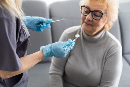 Close up portrait of elderly beautiful woman check up and having the consultation with dentist at the dental office.の写真素材
