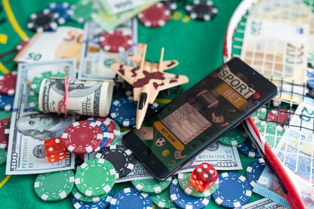 gamble. Poker concept.playing cards, chips and dollars are scattered around the new poker table.の写真素材