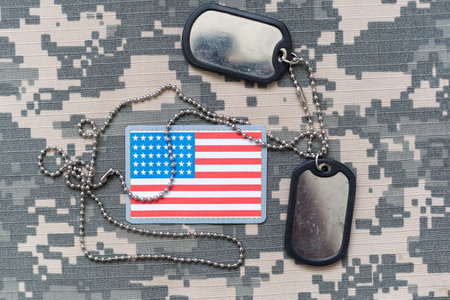 Military ID tags with USA flag on uniform backgroundの写真素材
