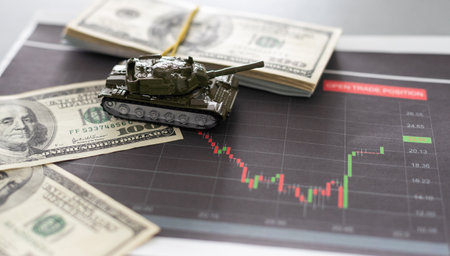 a toy tank, dollars and a tabletの写真素材