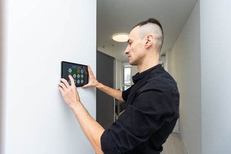 automation, internet of things and technology concept - man looking at tablet pc computer at smart...