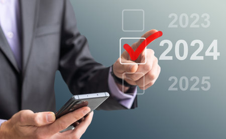 man hand touching on 2024 calender year button on digital virtual screen blur backgroundの写真素材