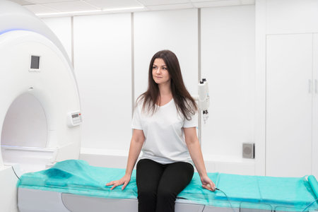 Female patient undergoing MRI - Magnetic resonance imaging in Hospital. Medical Equipment and Health...