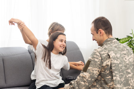 military father and two daughters at homeの写真素材