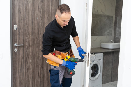master of installation and repair of door locks at workの写真素材