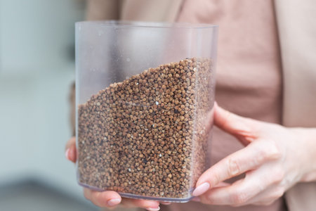 dry buckwheat and hand, healthy food concept