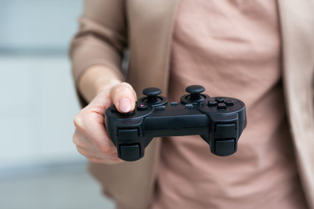 Womans hand playing video game against white background
