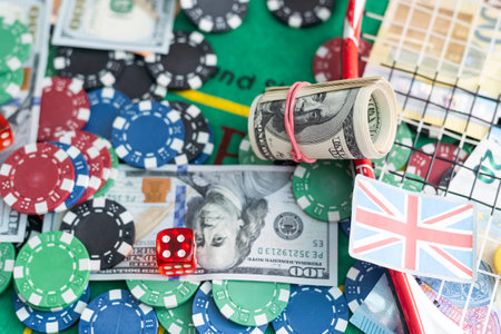 Dice with poker chips and playing card on background of dollar bills. Top view.の写真素材