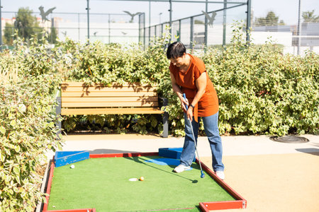Minigolf player detail on green grass