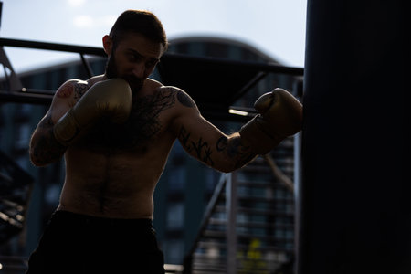 Part of man wearing boxing gloves.