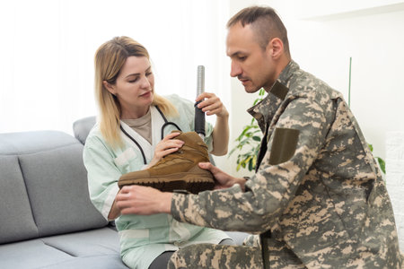 Physiotherapist helping young man with prosthetic legs