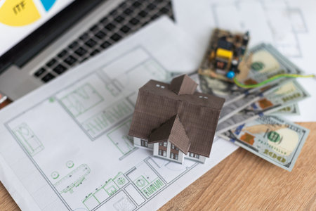 a toy house with banknotes, home insurance, mortgage, a symbol of material well-being