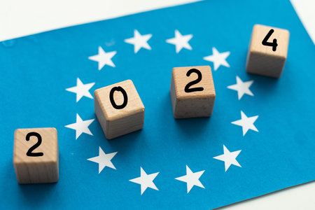 european union flag, cubes with 2024 on wooden table, European parliamen elections June 9, 2024,...