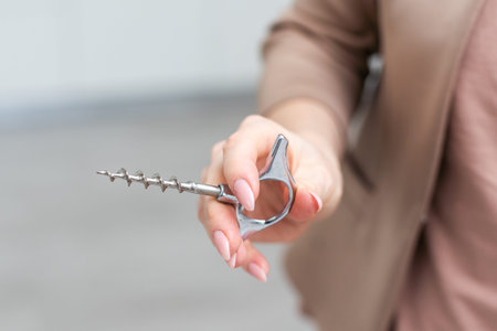 Hand holding corkscrew isolated on white background. Clipping path