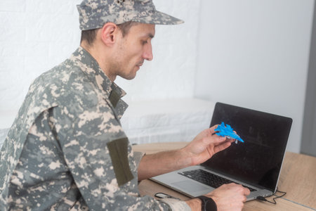 military man holding model fighter planeの写真素材