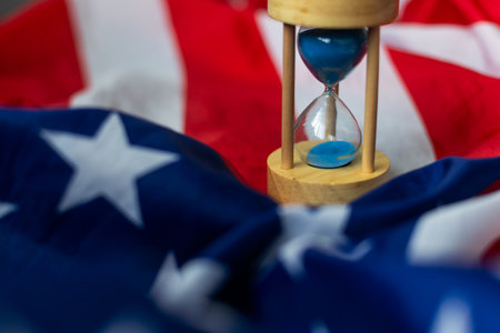 Hourglass and USA flag, soft focus, copy spaceの写真素材