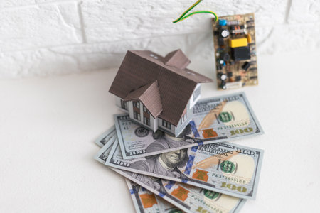House standing on a pile of dollar bills. Investment, real estate and property conceptの写真素材