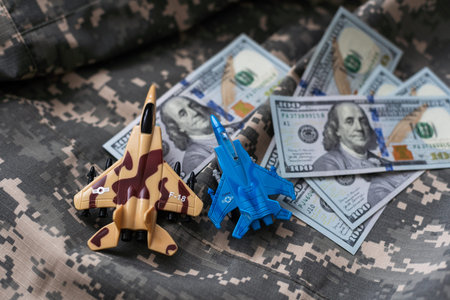Toy fighter. Airplane model on dollars background.