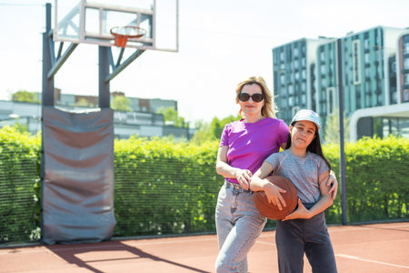 Mother and little daughter after basketball. Great job honey.