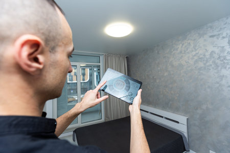 automation, internet of things and technology concept - man looking at tablet pc computer at smart...