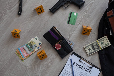 Crime scene investigation concept - Pistol and bullet shell against the yellow crime marker on...