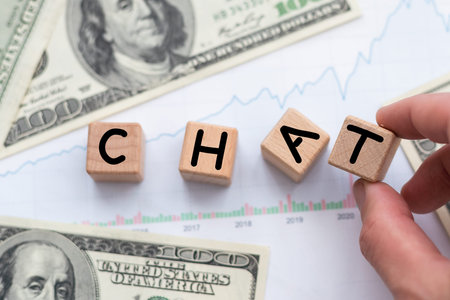 The word chat on wooden cubes with office desktop. Business, finance cash flow analysis concept.
