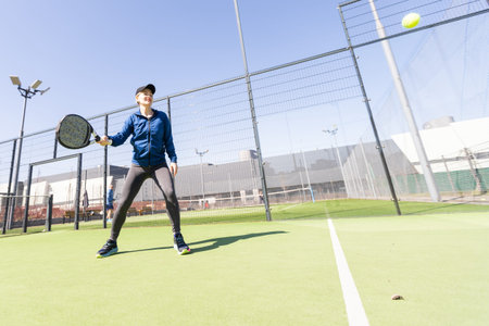 Paddle tennis woman image in court