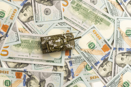 tank against the background of dollars. Concept of war.の写真素材