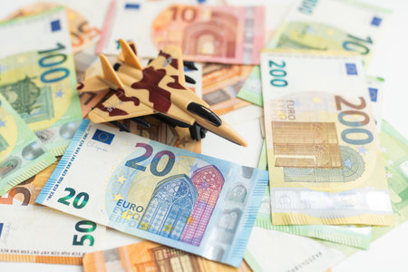 Background of one hundred dollar bills with model fighter airplaneの写真素材