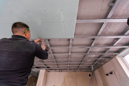 Construction worker, making walls from gypsum plasterboard or drywallの写真素材
