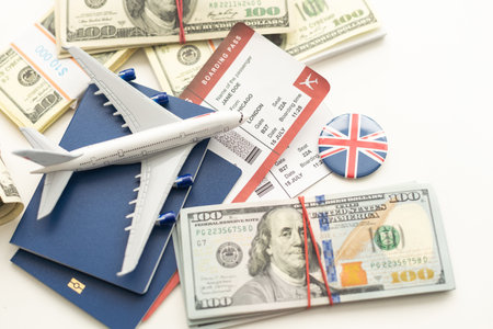 Airplane and money. Plane on the background of USA dollars. The cost of travel, air tickets and flights, financial expenses for vacation.の写真素材