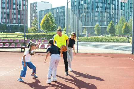 Time for family basketball. Family at basket playground.