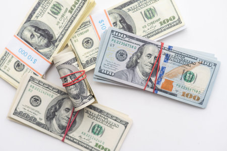 roles dollar notes in front of white background