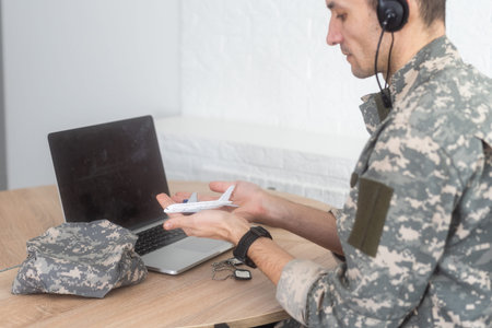 military man holding model plane
