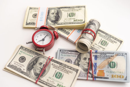 Time is money finance concept with old vintage clocks, dollar bills, spectacles and euro coins