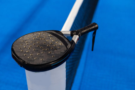 paddle tennis racket and balls on the blue paddle courtの写真素材