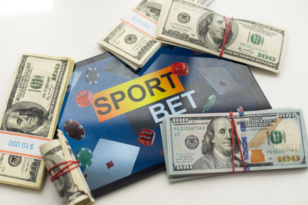 tablet pc with app for sport bets, on top of stacks of banknotes, white background, concept of online bets 3d renderの写真素材