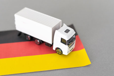 Mini toy at table with blurred background. Industrial shipping concept. toy truck, germany flagの写真素材