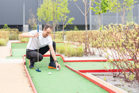 player looks at his hit on a mini golf course. High quality photoの写真素材