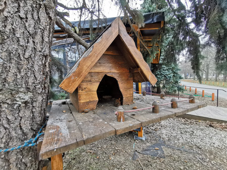 house in the forest for animals and birds. Wooden bird house in the summer park. on an tree stump. Old wooden feeder for birds on a tree, empty birds feeder caring about wild birds in cold season.の写真素材