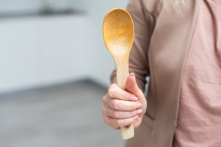 Wooden spoon in hand isolateの写真素材