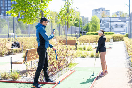 Mini-golf ball on artificial grass. Summer season game